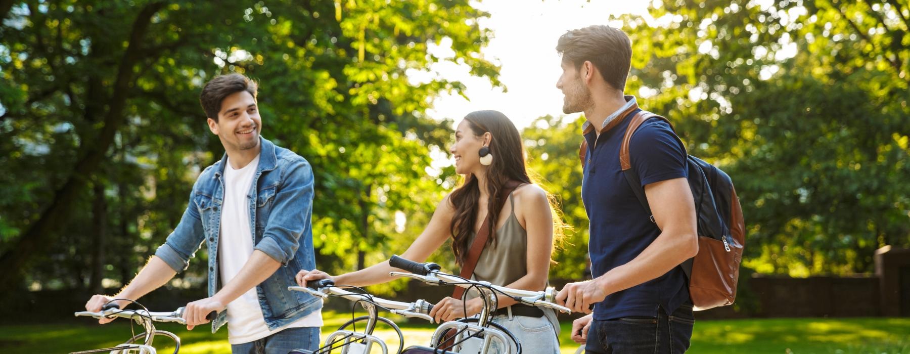 a group of people standing next to bicycles
